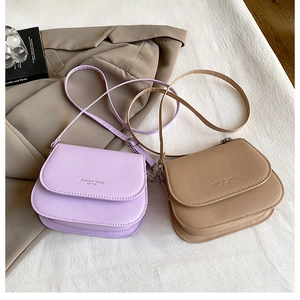 Detail of candy color flap crossbody bags in lavender and khaki with fashion text