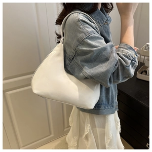 Detail of white PU leather crescent shoulder bag with smooth finish and fashion logo