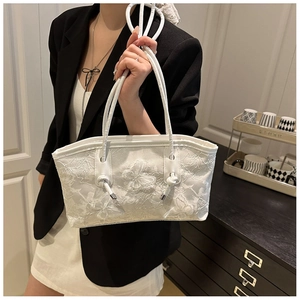 Detail of white tote bag with 3D butterfly embroidery and dual handles for women