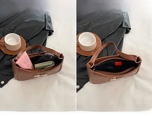Detail showing internal capacity of brown crocodile pattern handbag with golden bow