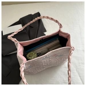 Detail of spacious interior pink bucket bag with jacquard fabric and magnetic closure
