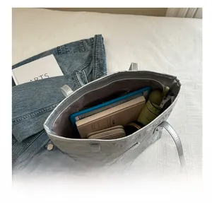 Silver metallic tote bag interior view showing large capacity for tablet and daily items