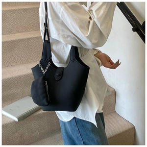 Detail of black lychee grain bucket bag with detachable coin purse on a model