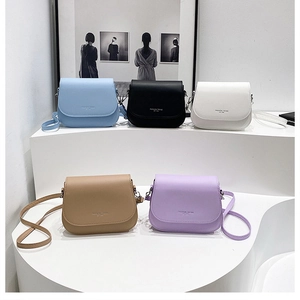 Detailed view of candy-colored crossbody bags in blue, black, white, khaki, and purple