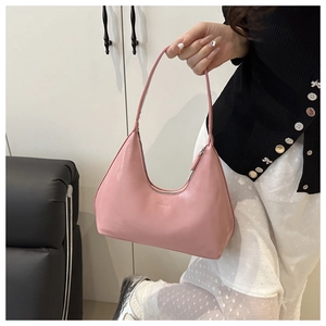 Close-up of pink leather hobo bag with embossed fashion logo and top zipper detail