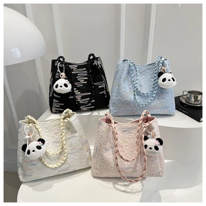 Macro view of textured quilted tote bags in four colors with panda plush pendants
