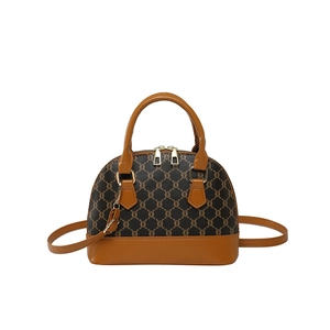 Vintage brown monogram shell bag with yellow trim and detachable shoulder strap