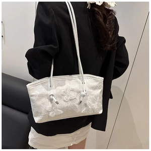 Detail of white lace tote bag featuring 3D butterfly appliques and elegant embroidery