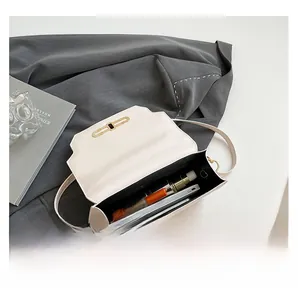 Detail showing the internal storage capacity of the cream leather crossbody bag