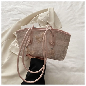 Detail of pink lace tote bag with 3D butterfly embroidery and knotted leather handle