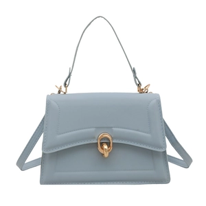 Minimalist light blue leather crossbody bag with geometric lines and gold ring buckle