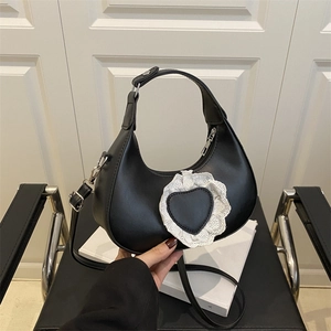 Black crescent moon handbag with lace heart detail and adjustable shoulder strap