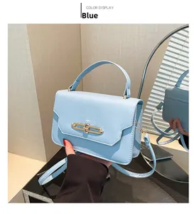 Detailed mirror view of a blue retro leather handbag with elegant gold metal clasp