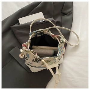 Detail of floral tapestry bucket bag showing spacious interior for phone and wallet