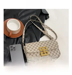 Detail view of vintage monogram flap shoulder bag with gold geometric buckle and strap
