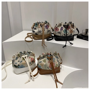 Detail of four vintage floral mini bucket bags with drawstring closure and leather base