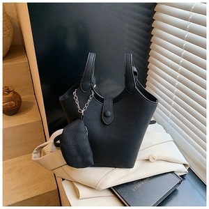 Detail of black lychee grain bucket bag with matching small coin purse and silver chain