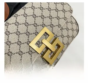 Detailed close-up of a vintage-style gold metal buckle and printed canvas fabric texture