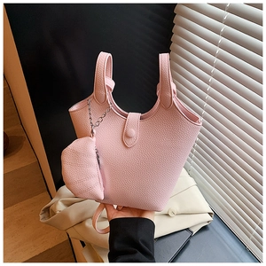Pink lychee grain bucket bag with a matching small pouch on a metal chain detail