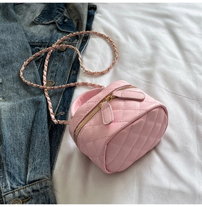 Detail of pink quilted leather mini chain bag showing fine stitching and metal zipper