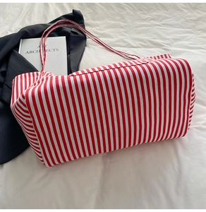 Detailed top view of a red and white striped canvas tote bag with a professional aesthetic