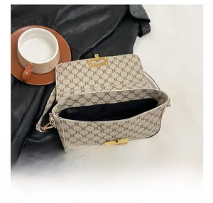 Detailed interior of vintage monogram crossbody bag showing spacious black lining and metal clasp