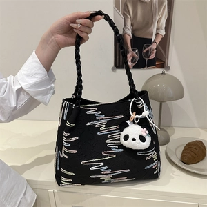 Large black canvas bucket bag with colorful wavy stripes and cute panda pendant charm