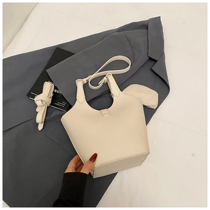 Detail of cream white bucket bag set with litchi texture and adjustable shoulder strap