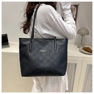 Stylish black large capacity tote bag featuring an embossed floral pattern and straps