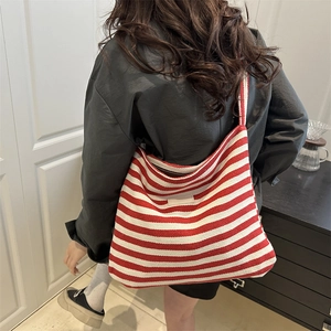 Fashionable red and white striped tote bag with large capacity for women on a model