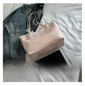 Pink tote bag detail with lace pearl bow charm and dual slim shoulder straps