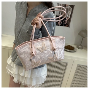 Side view of pink lace tote bag with floral patterns and 3D butterfly appliqués