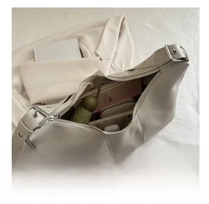 Top-down view showing interior capacity for daily essentials in this cream hobo shoulder bag