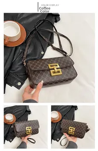 Detail view of coffee brown crossbody bag with vintage monogram and gold metal lock clasp
