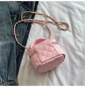 Detailed close-up of pink quilted mini box bag with gold chain strap and dual zippers