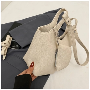 Detail of cream white litchi pattern bucket bag with detachable inner pouch and strap