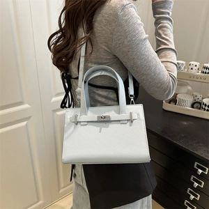 Classic light blue leather handbag with pebble texture and metallic twist lock