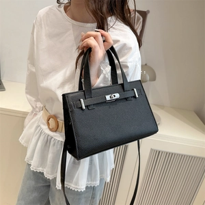 Classic black lychee pattern leather handbag with silver lock shown in a lifestyle setting