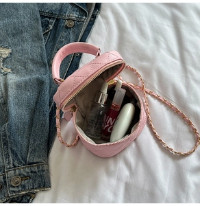 Pink quilted mini bag with golden chain strap showing compact interior for cosmetics