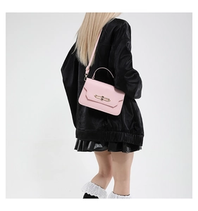 Detail of light pink crossbody bag with geometric flap and elegant gold metal lock