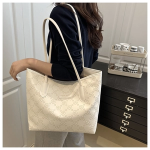 Detailed view of the elegant cream tote bag with delicate floral embossed patterns
