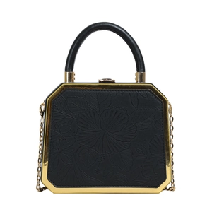 Elegant black hexagon handbag with floral embossing and gold metal chain link
