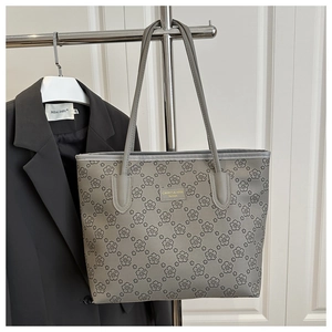 Elegant gray floral tote bag with large capacity hanging on a clothing rack for display
