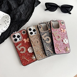 Luxury glitter iPhone case with rhinestone number 5, pearls, and butterfly charms.