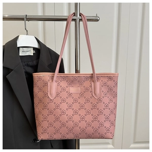 Spacious pink tote bag with dark flower patterns displayed on a silver metal rack