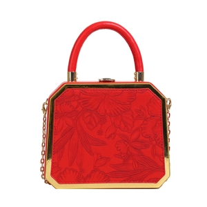 Elegant red octagonal box bag featuring floral embossing and gold chain strap detail