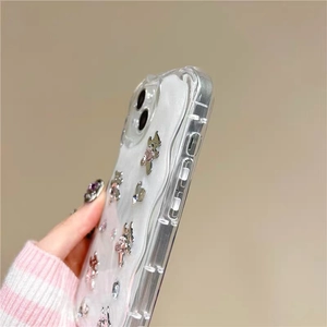 Detail showing 3D metal bears and rhinestones on wave-edge phone case for iPhone