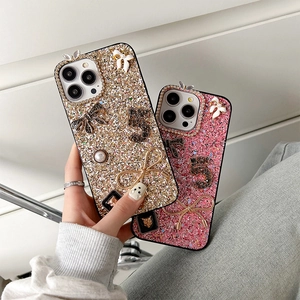 Detail of luxury iPhone case with glitter rhinestones, 3D bow, and pearl embellishments