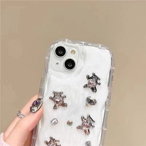 Detailed view of wavy phone case featuring silver bears and pink heart rhinestones