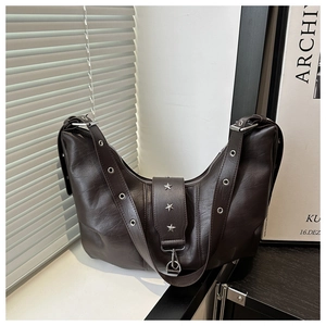 Detail of dark brown PU leather bag featuring silver star rivets and eyelet strap